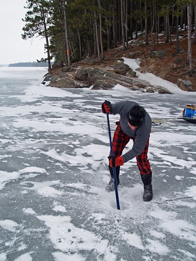 chiseling ice on lake opeongo